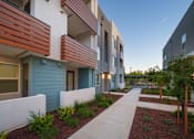 Thumbnail 10 of 12 - redesigned sidewalk in front of modern apartment buildings with a courtyard