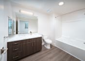 Thumbnail 4 of 12 - a bathroom with a toilet and a tub and a sink