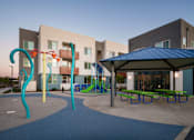 Thumbnail 8 of 12 - a playground and pavilion in a courtyard of an apartment building