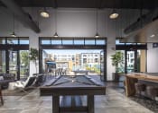 Thumbnail 5 of 28 - a pool table sits in the middle of a room with a bar