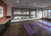 Thumbnail 10 of 28 - a yoga studio with purple mats on the floor