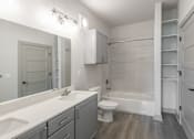 Thumbnail 12 of 34 - A white bathroom with a toilet, sink, and bathtub.at Allure Apartments LLC, Whiteland, 46184