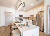 Thumbnail 4 of 34 - A modern kitchen with a long table and chairs.