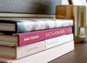 Thumbnail 25 of 34 - A stack of books with titles such as "Minol Araki" and "Picturing People" are displayed.