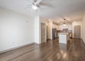 Thumbnail 15 of 34 - A spacious kitchen with a white island and wooden floors.