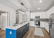 Thumbnail 2 of 29 - Modern kitchen with island and white cabinets at Viridian Apartments, Bowling Green, 42104