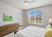 Thumbnail 12 of 29 - Bedroom with ceiling fan and large window at Viridian Apartments, Bowling Green