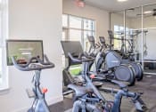Thumbnail 18 of 27 - a gym with various exercise bikes and cardio equipment at Arlington Farms, Greenwood, Indiana