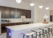 Thumbnail 16 of 27 - a kitchen with a long island with bar stools at Arlington Farms, Greenwood, Indiana
