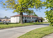 Thumbnail 16 of 30 - a large white house with a tree in front of it