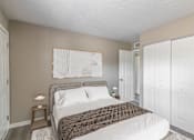 Thumbnail 3 of 30 - a bedroom with a bed and two closets