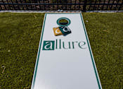 Thumbnail 46 of 48 - Cornhole board on grass near pool area at Allure Apartments, Indiana, 46184