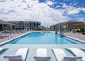 Thumbnail 19 of 48 - Resort style swimming pool with sun shelf loungers at Allure Apartments, Whiteland, IN 46184