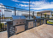 Thumbnail 40 of 48 - Outdoor kitchen with builtin grills and stone facade at Allure Apartments, Whiteland, IN