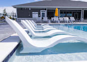 Thumbnail 45 of 48 - Swimming pool with inwater chaise lounges at Allure Apartments, Whiteland, IN