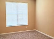 Thumbnail 4 of 10 - A room with a window covered in blinds.