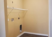 Thumbnail 7 of 10 - A white shelf is mounted on a wall with a white baseboard.
