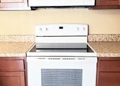 Thumbnail 9 of 10 - A white microwave oven is on top of a white oven.