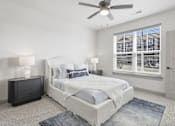 Thumbnail 6 of 29 - A bedroom with a large bed, a ceiling fan, and a window with blinds at The Warren Apartments, Jeffersonville, IN