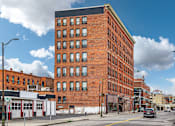 Thumbnail 39 of 68 - A large red brick building sits on a street corner at 206 Flats Apartments, Spokane