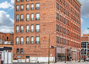 Thumbnail 38 of 68 - A large red brick building with a black roof and a white door at 206 Flats Apartments, Spokane, Washington