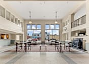 Thumbnail 29 of 68 - A large open kitchen and dining room with a fireplace and a view of the outdoors at 206 Flats Apartments, Spokane, WA