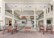 Thumbnail 21 of 68 - A large room with tables and chairs and a staircase at 206 Flats Apartments, Spokane, WA, 99201
