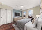 Thumbnail 34 of 68 - A bedroom with a large bed and a television at 206 Flats Apartments, Washington, 99201