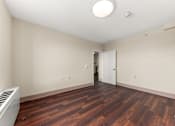 Thumbnail 5 of 68 - A room with a wooden floor and a white ceiling with a light fixture at 206 Flats Apartments, Spokane