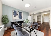 Thumbnail 12 of 68 - A modern dining room with a glass table and grey chairs at 206 Flats Apartments, Spokane