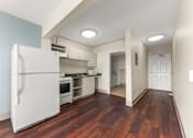 Thumbnail 11 of 68 - A white refrigerator is in a kitchen with wood floors at 206 Flats Apartments, Spokane, Washington
