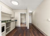 Thumbnail 68 of 68 - A kitchen with white appliances and wood floors at 206 Flats Apartments, Washington