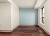 Thumbnail 54 of 68 - A room with a blue wall and wooden flooring at 206 Flats Apartments, Washington