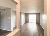 Thumbnail 22 of 24 - an empty living room with wood floors and a window
