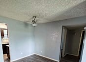 Thumbnail 24 of 24 - an empty living room with wood floors and a ceiling fan