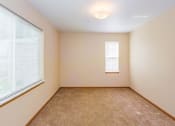 Thumbnail 2 of 23 - an empty room with two windows and a carpeted floor
