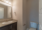 Thumbnail 10 of 18 - a bathroom with a toilet sink and mirror