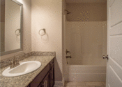 Thumbnail 8 of 18 - a bathroom with a sink and a bathtub