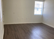 Thumbnail 8 of 9 - a bedroom with hardwood floors and a window