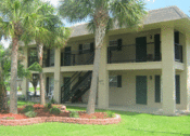 Thumbnail 3 of 9 - an exterior view of a large building with palm trees in front of it