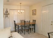 Thumbnail 16 of 19 - a dining room with a table and a couch