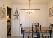 Thumbnail 18 of 19 - a dining room with a wooden table and chairs