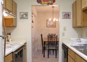 Thumbnail 14 of 19 - a kitchen and dining room with a table and chairs