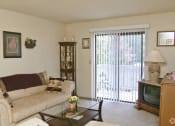 Thumbnail 17 of 19 - a living room with a couch and a television