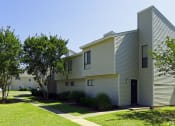 Thumbnail 5 of 19 - an exterior view of an apartment building with a sidewalk and grass