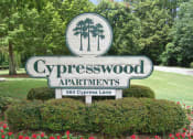 Thumbnail 19 of 19 - a sign for cypresswood apartments in front of a lawn and trees