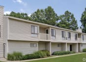Thumbnail 15 of 19 - a white apartment building with a balcony and grass
