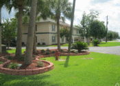 Thumbnail 7 of 9 - a view of a fire hydrant in a grassy area with a building in the background