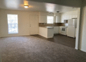 Thumbnail 5 of 9 - an empty kitchen and living room with a carpeted floor
