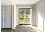 Thumbnail 10 of 23 - an empty room with a sliding glass door